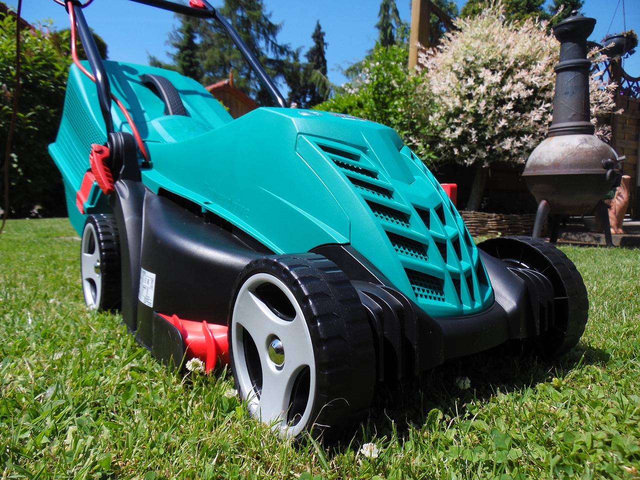 a green lawn mower on grass